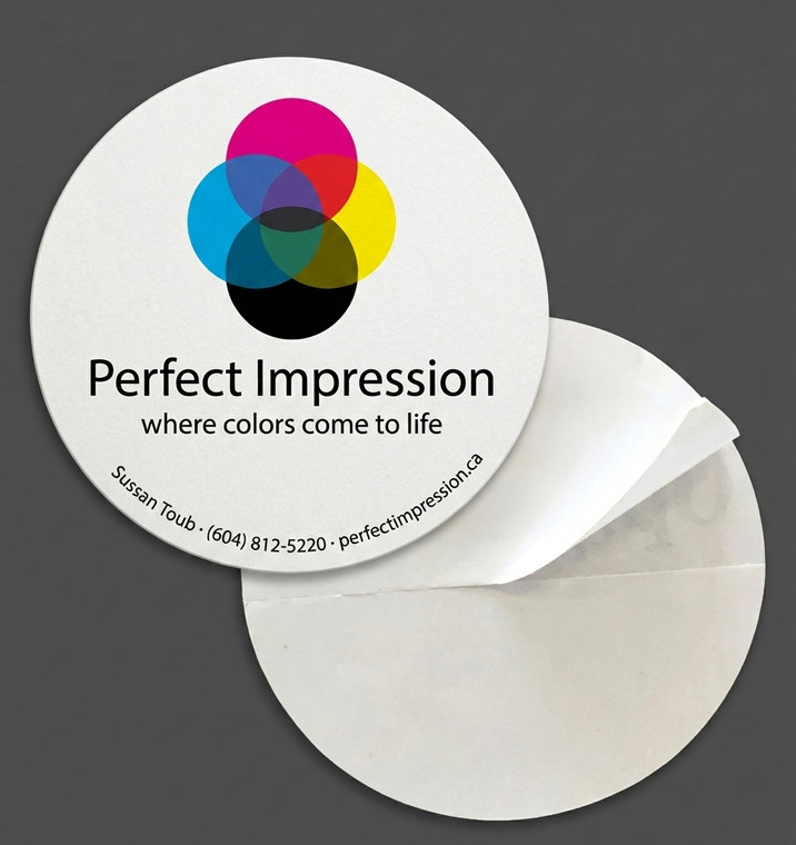 A round sticker peeling off its backing